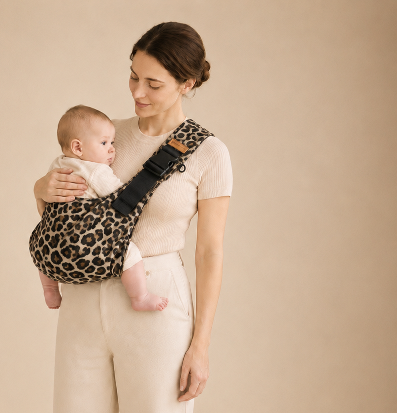 Parent carrying baby in a Kowala sling